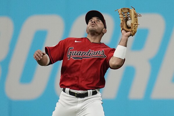 FILE - Cleveland Guardians right fielder Ramón Laureano catches a fly ball hit by Toronto Blue Jays' Whit Merrifield during the eighth inning of a baseball game Aug. 8, 2023, in Cleveland. The Guardians have avoided salary arbitration with Laureano, signing him to a one-year contract before the 8 p.m. deadline Friday, Nov. 17, 2013. Financial terms were not immediately known. (AP Photo/Sue Ogrocki, File)