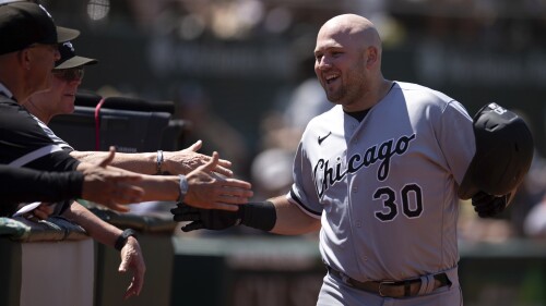 Chicago White Sox's Jake Burger (30) is congratulated by his teammates after hitting a solo home run against the Oakland Athletics during the seventh inning of a baseball game, Sunday, July 2, 2023, in Oakland, Calif. (AP Photo/D. Ross Cameron)