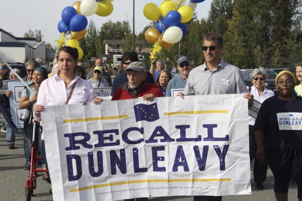 FILE - In this Sept. 5, 2019, file photo, Meda DeWitt, left, Vic Fischer, middle, and Aaron Welterlen, leaders of an effort to recall Alaska Gov. Mike Dunleavy, lead about 50 volunteers in a march to the Alaska Division of Elections office in Anchorage, Alaska. The campaign aimed at recalling Alaska Gov. Dunleavy says it is ceasing that effort, with a gubernatorial election looming next year. The Recall Dunleavy group says as of Saturday, Aug. 21, it had gathered 62,373 signatures, shy of the 71,252 needed for a recall election. (AP Photo/Mark Thiessen, File)