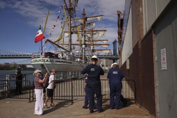 The coastal guards of the United States arrive on Sunday, May 18, 2025, at Pier 35 in New York, where the Cuauhtémoc, a Mexican training ship of the Mexican Navy, which collided with the Brooklyn Bridge the night before, sits. (AP Photo/Yuki Iwamura)