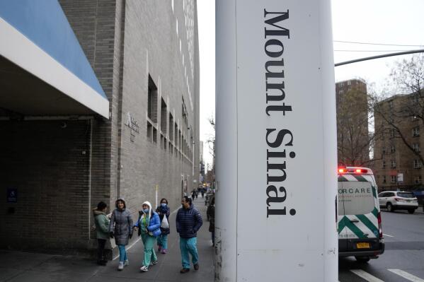 People enter Mount Sinai Hospital in New York, Thursday, Jan. 12, 2023. Two New York City hospitals have reached a tentative contract agreement with thousands of striking nurses that ends the walkout, the nurses' union announced today. (AP Photo/Seth Wenig)
