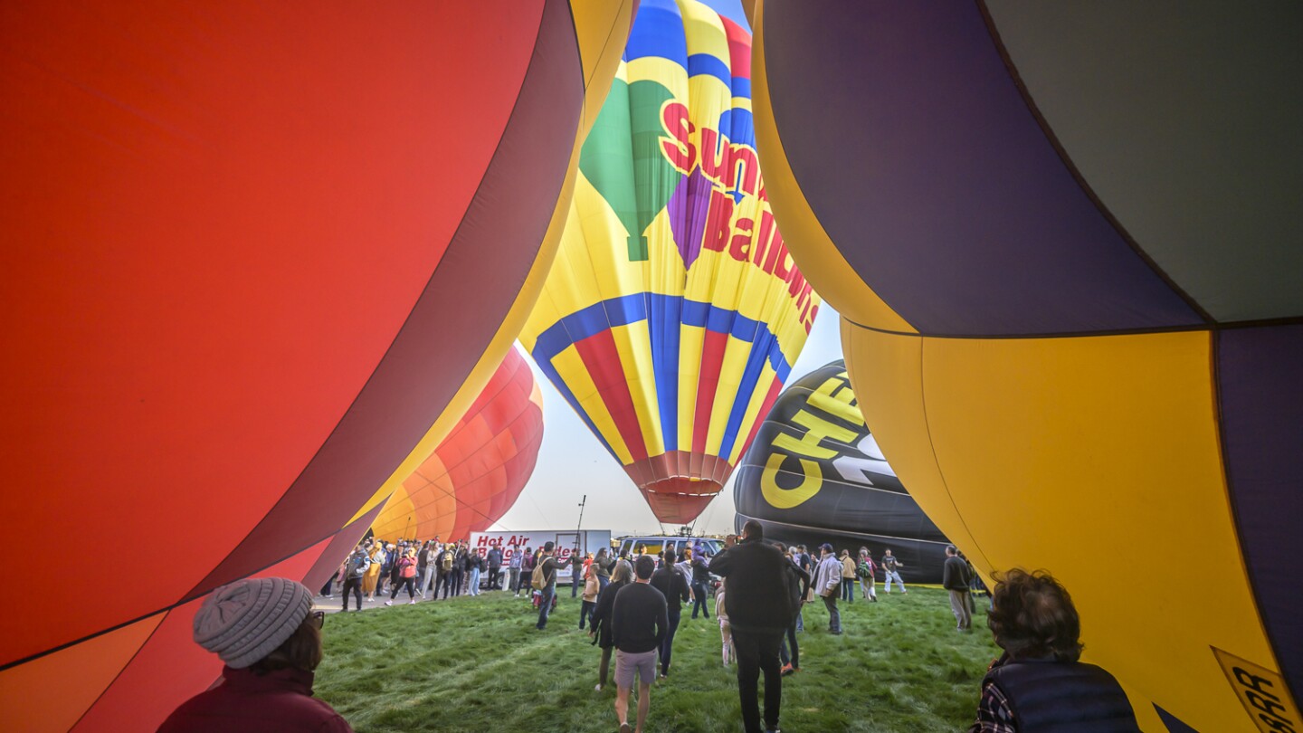 “Magical” flotilla of hot air balloons takes off in warm temperatures at international festival