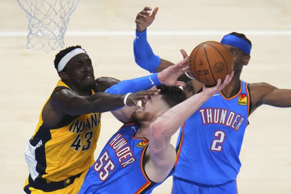 Indiana Pacers forward Pascal Siakam (43) defends against Oklahoma City Thunder center Isaiah Hartenstein (55) during the first half of Game 7 of the NBA Finals basketball series Sunday, June 22, 2025, in Oklahoma City. (AP Photo/Julio Cortez)