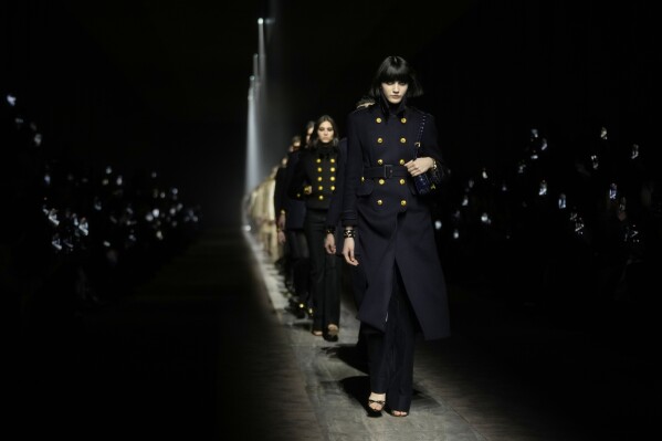 Models wear creations as part of the Tom Ford women's Fall-Winter 2024-25 collection presented in Milan, northern Italy, Thursday, Feb. 22, 2024. (AP Photo/Luca Bruno)