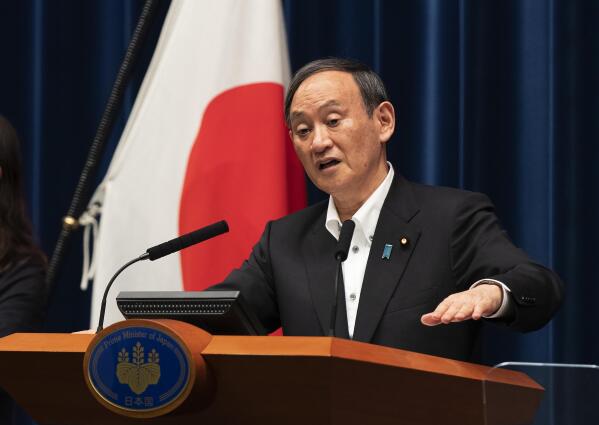 Japanese Prime Minister Yoshihide Suga responds to a reporter's question after he spoke at a news conference in Tokyo on Friday, May 7, 2021. Suga announced an extension of a state of emergency in Tokyo and other areas through May 31. (AP Photo/Hiro Komae)
