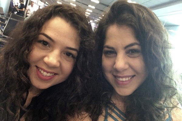 This photo provided by Neima Benavides, right, shows her and her sister, Naibel Benavides Leon in the Dominican Republic in 2018, celebrating Naibel's 21st birthday. (Neima Benavides via AP)