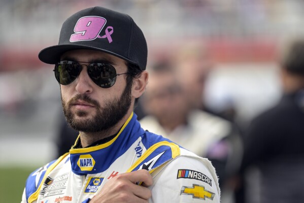 FILE - Chase Elliott (9) looks on prior to a NASCAR Cup Series auto race at Charlotte Motor Speedway, Sunday, Oct. 9, 2022, in Concord, N.C. Elliott prefers to view a very challenging season as opportunity, not pressure. The 2022 Cup Series champ who won last year's regular season title sits 27th in the points standings as NASCAR returns from the lone break in the 38-race season. (AP Photo/Matt Kelley, File)
