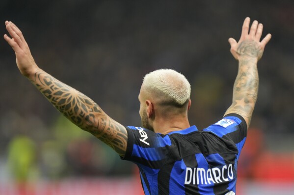 Inter Milan's Federico Dimarco celebrates after scoring his side's opening goal during a Serie A soccer match between Inter Milan and Frosinone, at the San Siro stadium in Milan, Italy, Sunday, Nov. 12, 2023. (AP Photo/Luca Bruno)
