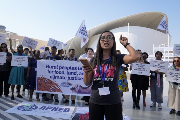 Activists demonstrate for rural people, food, land and climate justice at the COP28 U.N. Climate Summit, Wednesday, Dec. 6, 2023, in Dubai, United Arab Emirates. (AP Photo/Kamran Jebreili)