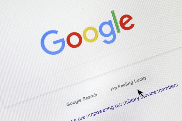 FILE - A cursor moves over Google's search engine page, Aug. 28, 2018, in Portland, Ore. On Tuesday, Sept. 26, 2023, a top Apple executive defended the tech giant’s decision to make Google the default search engine on Apple iPhones and Macs, saying there was no “valid alternative.’’ (AP Photo/Don Ryan, File)