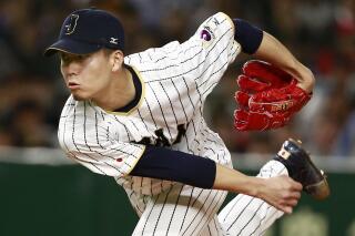 FILE - Japan's starter Kodai Senga pitches against Israel during the first inning of a second-round game at the World Baseball Classic in Tokyo, March 15, 2017. Senga and the New York Mets have agreed to a $75 million, five-year contract, according to a person familiar with the negotiations. The person spoke on condition of anonymity early Sunday, Dec. 11, 2022, because the deal was pending a physical. (AP Photo/Shizuo Kambayashi, File)