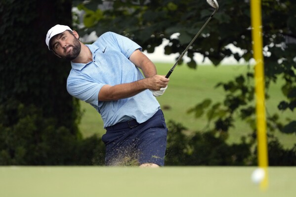 Scottie Scheffler hits onto a practice green at the St. Jude Championship golf tournament, Wednesday, Aug. 14, 2024, in Memphis, Tenn. The tournament is scheduled to begin Thursday. (AP Photo/Mark Humphrey)