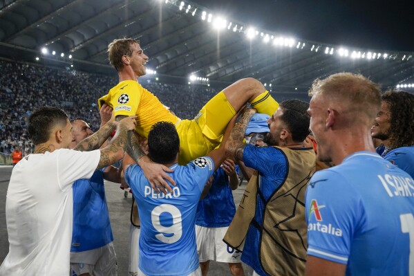 Lazio's goalkeeper Ivan Provedel celebrates with his teammates at the end of a Champions League group E soccer match between Lazio and Atletico Madrid, at Rome's Olympic Stadium, Tuesday, Sept. 19, 2023. (AP Photo/Andrew Medichini)