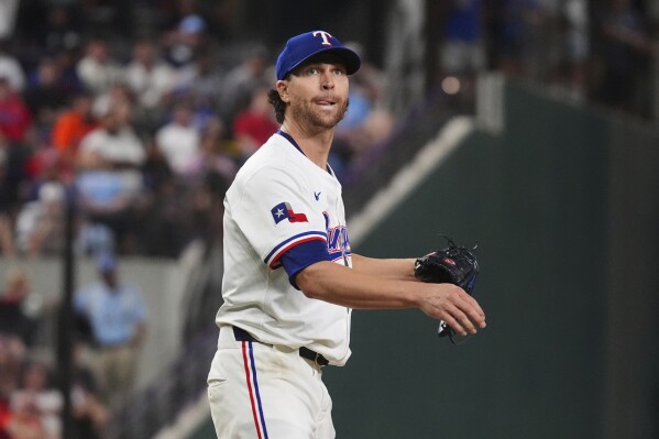 Texas Rangers starting pitcher Jacob deGrom watches a hit ball go foul during the seventh inning of a baseball game against the Houston Astros, Thursday, May 15, 2025, in Arlington, Texas. (AP Photo/LM Otero)