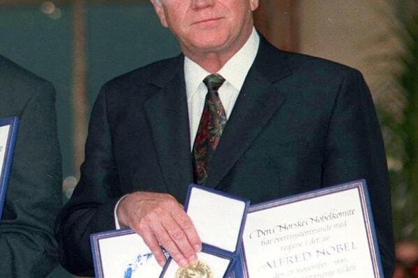 FILE- Former South African President F.W. de Klerk,poses with his Nobel Peace Prize Gold Medal and Diploma, in Oslo, Dec. 10, 1993. The medal awarded nearly 30 years ago to de Klerk, was stolen from his Cape Town home in April, his foundation said Wednesday Nov. 9, 2022. (Jon Eeg/Pool photo via AP, File)