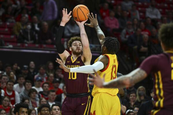 FILE - Minnesota forward Jamison Battle (10) shoots the ball against Maryland guard Hakim Hart (13) during the first half of an NCAA college basketball game, Wednesday, March 2, 2022, in College Park, Md. Battle is Minnesota's lone returning starter who ranked seventh in the Big Ten in scoring last season. (AP Photo/Terrance Williams, File)
