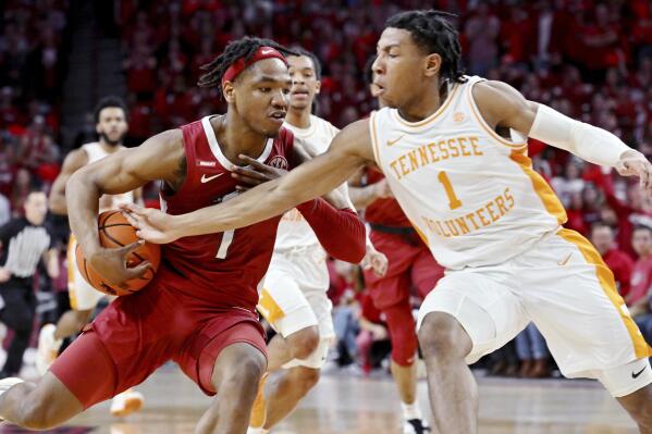 Arkansas guard JD Notae, left, tries to get past Tennessee guard Kennedy Chandler, right, during the first half of an NCAA college basketball game Saturday, Feb. 19, 2022, in Fayetteville, Ark. (AP Photo/Michael Woods)