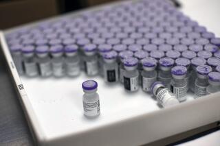FILE - In this Monday, Jan. 4, 2021 file photo, frozen vials of the Pfizer/BioNTech COVID-19 vaccine are taken out to thaw, at the MontLegia CHC hospital in Liege, Belgium. The U.S. will buy 500 million more doses of the Pfizer COVID-19 vaccine to share through the COVAX alliance for donation to 92 lower income countries and the African Union over the next year, a person familiar with the matter said Wednesday. President Joe Biden was set to make the announcement Thursday in a speech before the start of Group of Seven summit. (AP Photo/Francisco Seco, File)