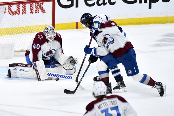 Colorado Avalanche goaltender Alexandar Georgiev (40) makes a save against Winnipeg Jets' Alex Iafallo (9) during the third period in Game 2 of an NHL hockey Stanley Cup first-round playoff series Tuesday, April 23, 2024, in Winnipeg, Manitoba. (Fred Greenslade/The Canadian Press via AP)