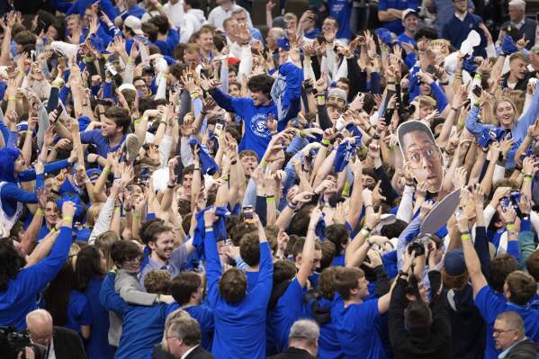 Creighton fans storm the court following the team's 85-66 win over UConn in an NCAA college basketball game Tuesday, Feb. 20, 2024, in Omaha, Neb. (AP Photo/Rebecca S. Gratz)