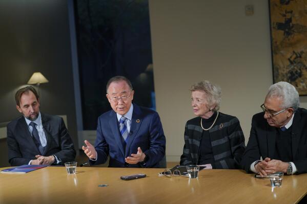 Zeid Raad Al Hussein, left, Mary Robinson, second from right, and Ernesto Zedillo, right, listen as former United Nations Secretary-General Ban Ki-moon speaks during an interview with The Associated Press, Friday, Nov. 4, 2022, in New York. (AP Photo/Mary Altaffer)