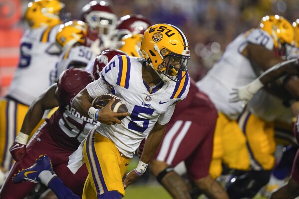 LSU quarterback Jayden Daniels (5) carries on a keeper in the second half of an NCAA college football game against Arkansas in Baton Rouge, La., Saturday, Sept. 23, 2023. LSU won 34-31. (AP Photo/Gerald Herbert)