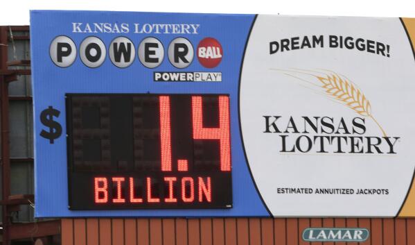 FILE - A record Powerball jackpot is posted on a Kansas Lottery billboard in Topeka, Kan., on Monday, Jan. 11, 2016. State lotteries spend more than a half-billion dollars a year on pervasive marketing campaigns that deliver hopeful messages, designed to persuade people to play often, spend more and overlook the long odds of winning. But for every dollar players spend on the lottery, they will lose about 35 cents on average, according to an analysis in 2021 of lottery data by the Howard Center for Investigative Journalism at the University of Maryland. (AP Photo/Orlin Wagner, File)