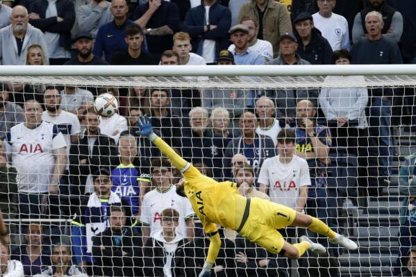 Tottenham's goalkeeper Hugo Lloris dives but fails to save the goal from Leicester's James Maddison during the English Premier League soccer match between Tottenham Hotspur and Leicester City at Tottenham Hotspur Stadium, in London, Saturday, Sept. 17, 2022. (AP Photo/David Cliff)