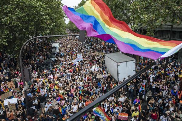 FILE - In this file photo dated Saturday, June 26, 2021, crowds are seen at the annual Gay Pride march in Paris, France.  France’s lower house of parliament on Tuesday June 29, 2021, is to approve a bioethics law that will allow single women and lesbians to have access to medically assisted reproduction for the first time, a change much awaited by many LGBT groups. (AP Photo/Lewis Joly, FILE)