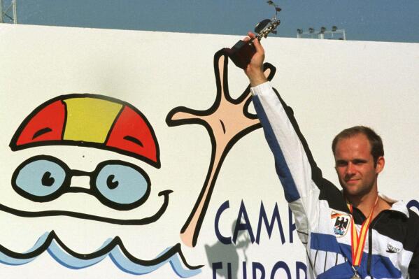 FILE - German gold medalist in the 10 meter diving competition Jan Hempel, poses with his trophy on Aug. 18, 1997 in the European Swimming Championships in Seville, Spain. Former Olympic diver Jan Hempel has accused the German swimming federation of failing to heed his complaints of his years-long sexual abuse by former coach Werner Langer. “The federation (DSV) suggested to me that if I spread that around, it would put our sport in danger and then you can’t take part in your sport anymore. Of course, I was at a level where I had goals in mind and I wanted to reach them,” Hempel told news agency DPA on Friday, Aug. 19, 2022. (AP Photo/Christof Stache, File)