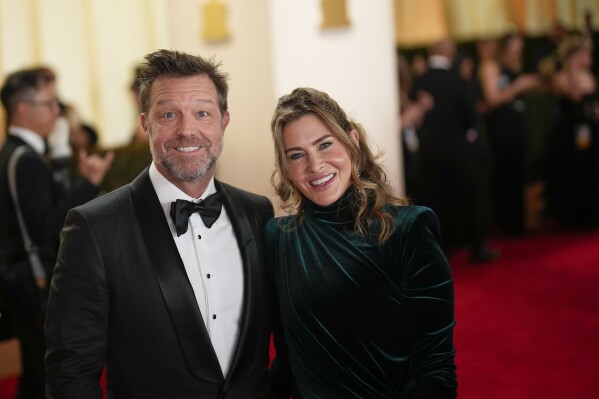 David Leitch, left, and Kelly McCormick arrive at the Oscars on Sunday, March 10, 2024, at the Dolby Theatre in Los Angeles. (AP Photo/John Locher)