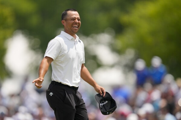 Xander Schauffele smiles after the first round of the PGA Championship golf tournament at the Valhalla Golf Club, Thursday, May 16, 2024, in Louisville, Ky. (AP Photo/Matt York)