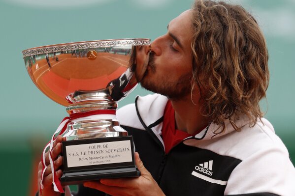 Stefanos Tsitsipas of Greece kisses the trophy after defeating Andrey Rublev of Russia in the Monte Carlo Tennis Masters tournament finals in Monaco, Sunday, April 18, 2021. (AP Photo/Jean-Francois Badias)