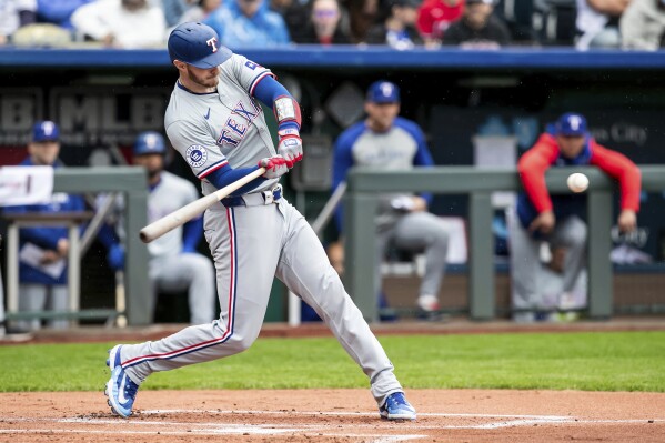 Texas Rangers' catcher Jonah Heim takes a swing at the ball during a baseball game against the Kansas City Royals, Sunday, May 5, 2024, in Kansas City, Mo. (AP Photo/Nick Tre. Smith)