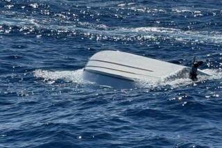 This image provided by the U.S. Coast Guard on Monday, April 14, 2025, shows a capsized boat off Florida's Atlantic Coast. (U.S. Coast Guard via AP)