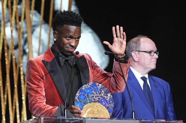 Real Madrid's Vinicius Junior, left, receives the Socrates Award by Prince Albert II of Monaco during the 67th Ballon d'Or (Golden Ball) award ceremony at Theatre du Chatelet in Paris, France, Monday, Oct. 30, 2023. (AP Photo/Michel Euler)