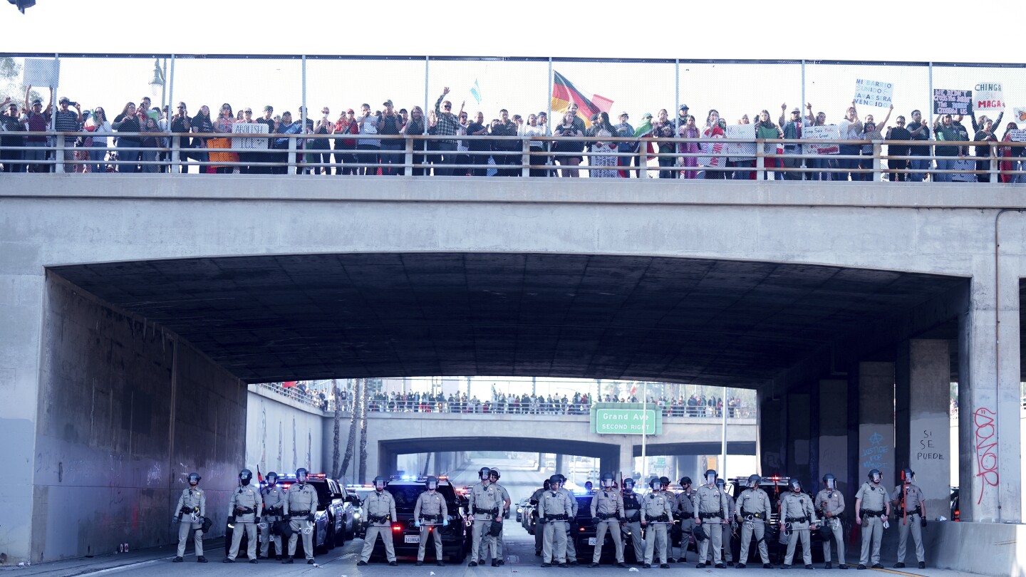 Marchers protesting planned deportations block major freeway in Los Angeles