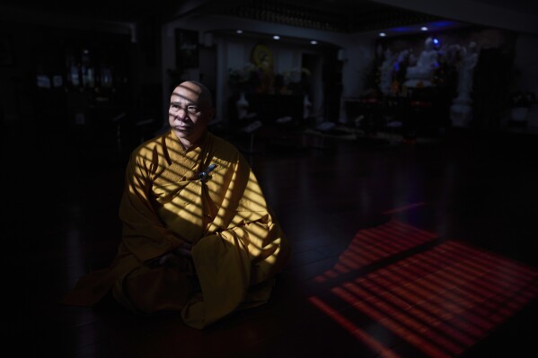 Vietnamese monk Tu Truong, 52, who said he came to the U.S. in 1993 through the Humanitarian Operation program, sits for a photo at his Buddhist temple in the Little Saigon neighborhood of Westminster, Calif., Tuesday, April 22, 2025. (AP Photo/Jae C. Hong)