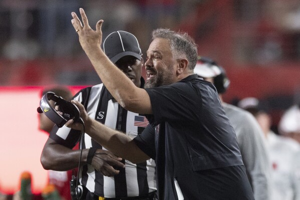 Nebraska head coach Matt Rhule lets referees know he did not call a timeout against Northern Illinois during the second half of an NCAA college football game, Saturday, Sept. 16, 2023, in Lincoln, Neb. (AP Photo/Rebecca S. Gratz)