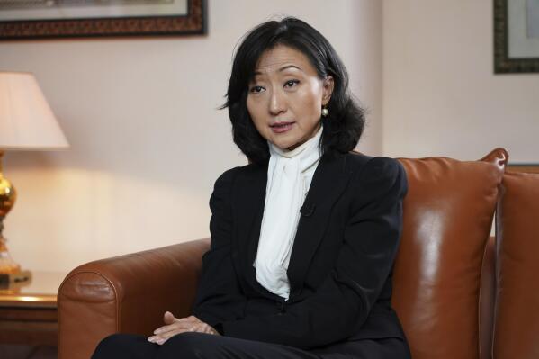 Grace Meng, the wife of former Interpol president Meng Hongwei, answers the Associated Press in Lyon, central France, Tuesday, Nov.16, 2021. In the exclusive interview, Meng chose to show her face for the first time since her husband disappeared in China in 2018, agreeing to be filmed and photographed without the dark lighting and from-the-back camera angles that she had previously insisted on.  (AP Photo/Laurent Cipriani)