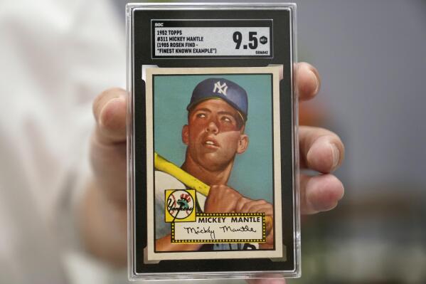 FILE - A Mickey Mantle baseball card is displayed at Heritage Auctions in Dallas, on July 21, 2022. A mint condition Mickey Mantle baseball card has sold for $12.6 million, blasting into the record books Sunday Aug. 28, 2022 as the most expensive ever paid for a piece of sports memorabilia. (AP Photo/LM Otero, File)