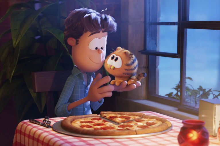 This image released by Sony Pictures shows characters Jon, voiced by Nicholas Hoult, left, and Garfield, voiced by Chris Pratt, in a scene from the animated film "The Garfield Movie." (Columbia Pictures/Sony via AP)
