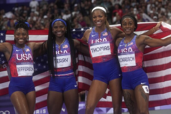 United States women's 4x100-meter relay final team pose for a photo after winning the gold medal at the 2024 Summer Olympics, Friday, Aug. 9, 2024, in Saint-Denis, France. (AP Photo/Bernat Armangue)