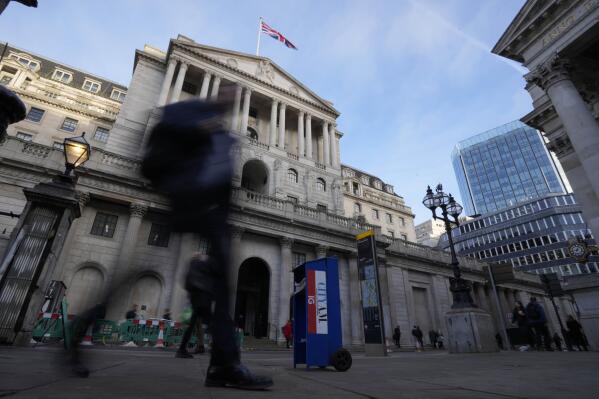 People walk past the Bank of England in London, Thursday, Feb. 2, 2023. The Bank of England is expected to raise interest rates by as much as half a percentage point. That would outpace the latest hike by the U.S. Federal Reserve. The move on Thursday comes as the central bank seeks to tame decades-high inflation that has driven a cost-of-living crisis and predictions of recession. (AP Photo/Frank Augstein)