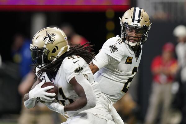New Orleans Saints quarterback Jameis Winston (2) hands the ball off to New Orleans Saints running back Alvin Kamara (41) during the first half of an NFL football game, Sunday, Sept. 11, 2022, in Atlanta. (AP Photo/Brynn Anderson)