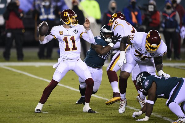 Washington Football Team's Alex Smith plays during the first half of an NFL football game against the Philadelphia Eagles, Sunday, Jan. 3, 2021, in Philadelphia. Alex Smith is the biggest reason Washington became the first team in the Super Bowl era to start 2-7 and make the playoffs. The 36-year-old’s journey back from a broken leg and 17 surgeries was a long one, but the difference with him at quarterback has been simple: Smith doesn’t make major mistakes, manages the game and is the cool hand coach Ron Rivera wanted in control of his young team. (AP Photo/Derik Hamilton, File)