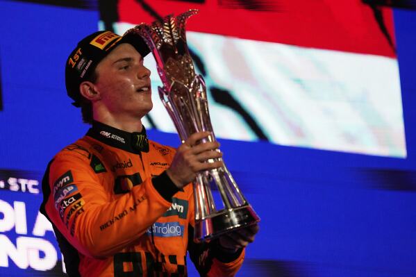 McLaren driver Oscar Piastri of Australia celebrates on the podium after winning the Formula One Saudi Arabian Grand Prix at the Jeddah Corniche Circuit in Jeddah, Saudi Arabia, Sunday, April 20, 2025. (AP Photo/Darko Bandic)
