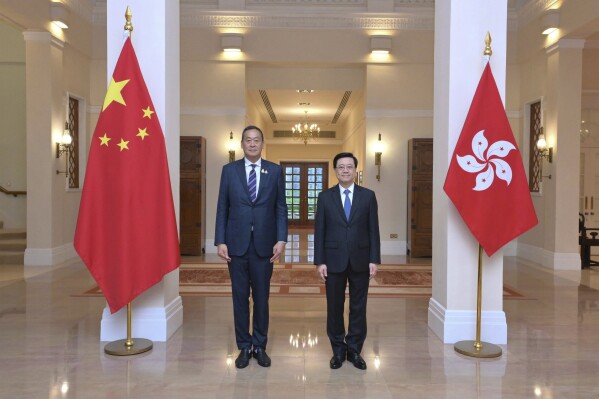 In this photo released by the Hong Kong Government Information Services Department, Hong Kong Chief Executive John Lee, right, and Thailand's Prime Minister Srettha Thavisin stand for a photograph during their meeting at Government House in Hong Kong on Monday, Oct. 9, 2023. Hong Kong's leader said Tuesday the city would seek to strengthen its economic and trade ties with Thailand after a meeting with the country's prime minister, as the Chinese financial hub looks for more business opportunities in Southeast Asia. (Hong Kong Government Information Services Department via AP)