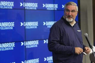 Indiana Gov. Eric Holcomb speaks during a news conference announcing that the Indiana Pacers basketball arena will be renamed Gainbridge Fieldhouse during the NBA basketball team's media day in Indianapolis, Monday, Sept. 27, 2021. (AP Photo/AJ Mast)