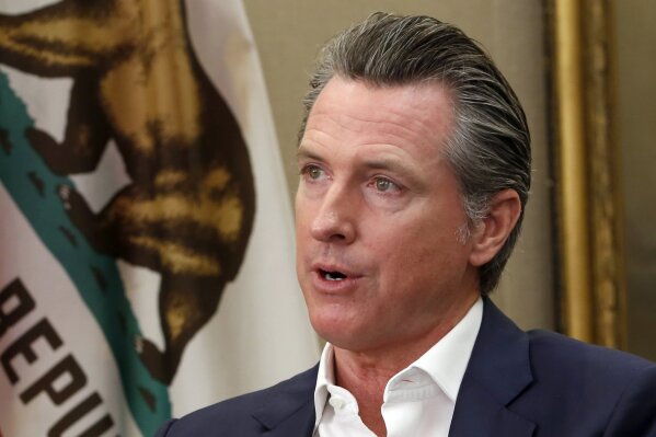 This Oct. 8, 2019, photo shows Gov. Gavin Newsom during an interview in his office at the Capitol in Sacramento, Calif. California schools will get to decide if parents can administer medical marijuana to their children on school campuses after Newsom announced Wednesday he has signed legislation that reverses a prohibition on cannabis within 1,000 feet of K-12 campuses. School districts will have the final say on whether they will allow it. (AP Photo/Rich Pedroncelli, File)